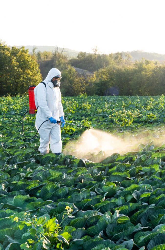 farmer spraying pesticide field mask harvest protective chemical