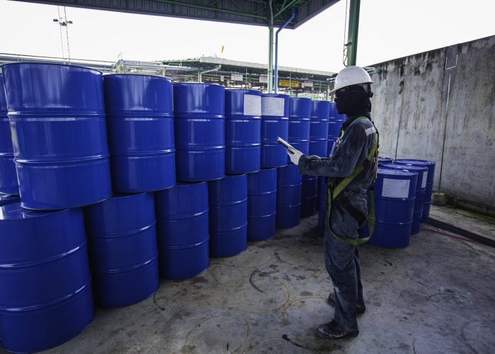 male worker inspection record drum oil stock barrels blue vertic male worker inspection record drum oil stock barrels blue vertic